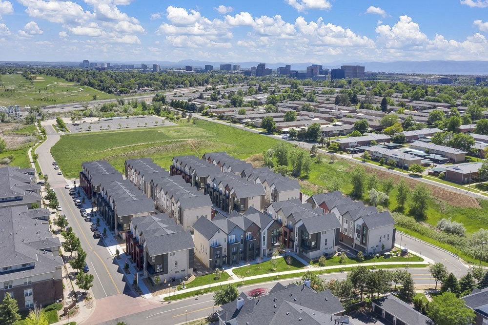Ariel view of entire townhome complex with greenery surrounding.