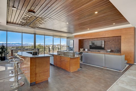 resident lounge with community kitchen, couches, work form home stations and mountain views