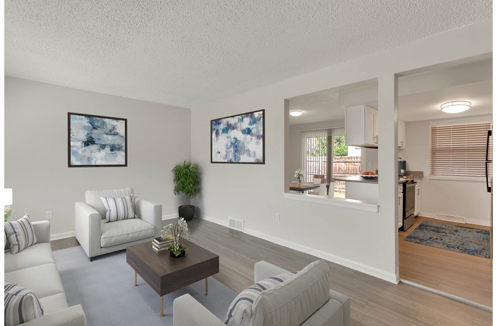 Spacious living room with faux wood laminate flooring.