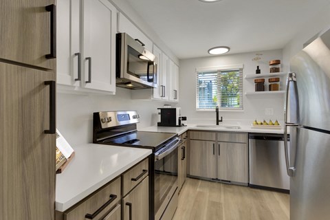 a kitchen with stainless steel appliances and white cabinets