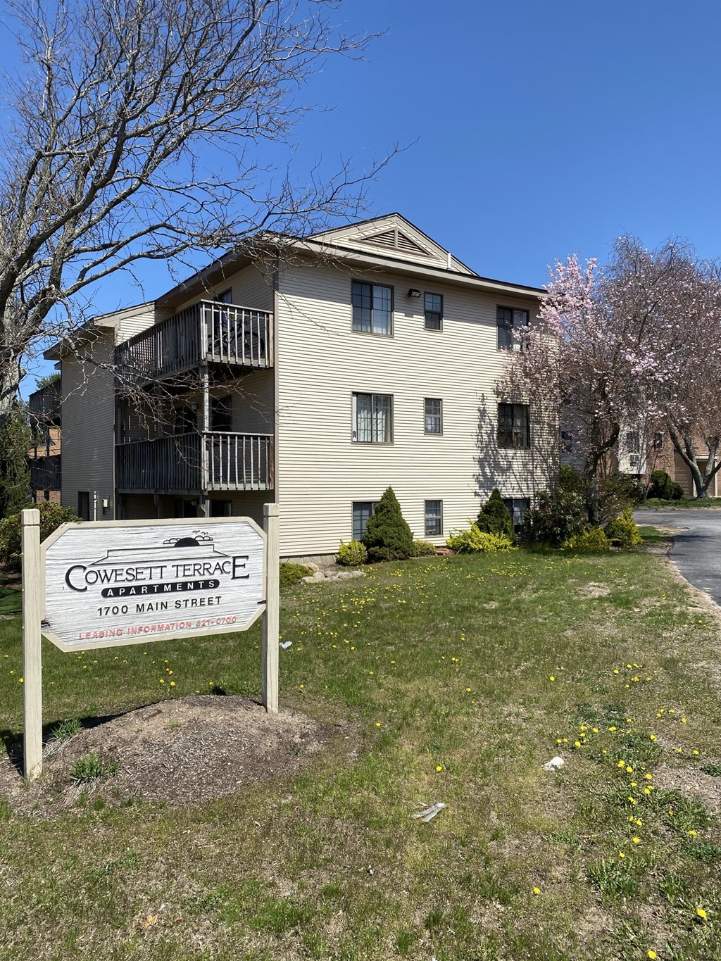 an apartment building with a sign in front of it