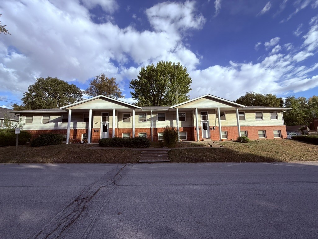 A building with a red brick facade and a white roof.