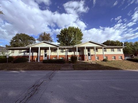 A building with a red brick facade and a white roof.