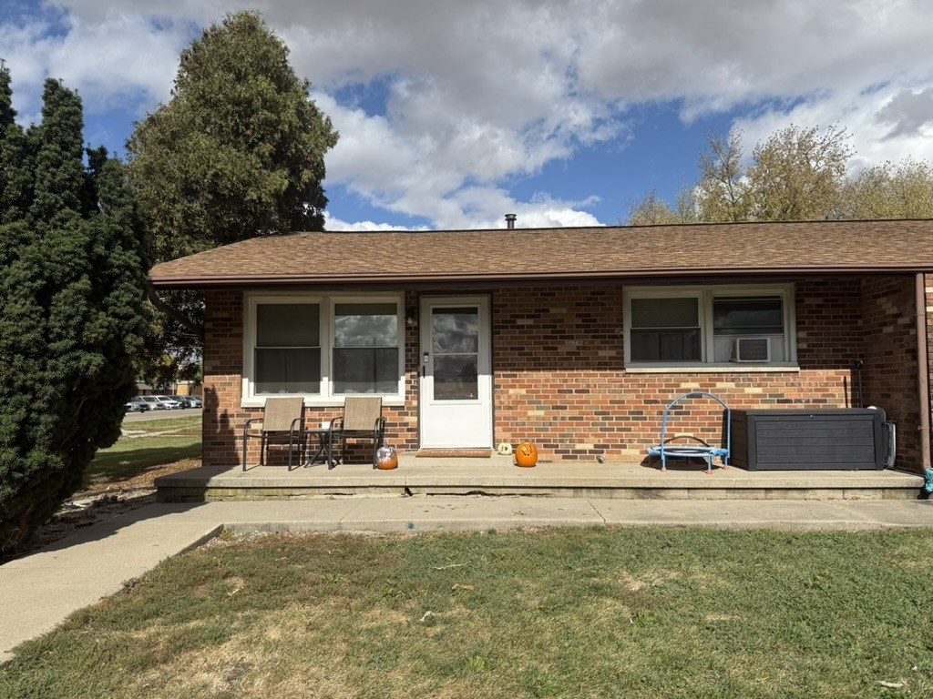A house with a white door and a brown roof.