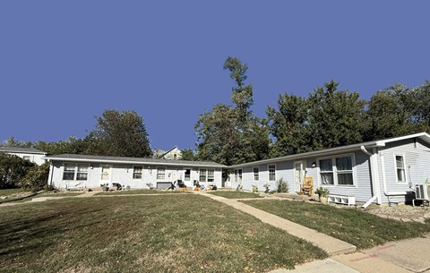 A row of houses with a clear blue sky above.