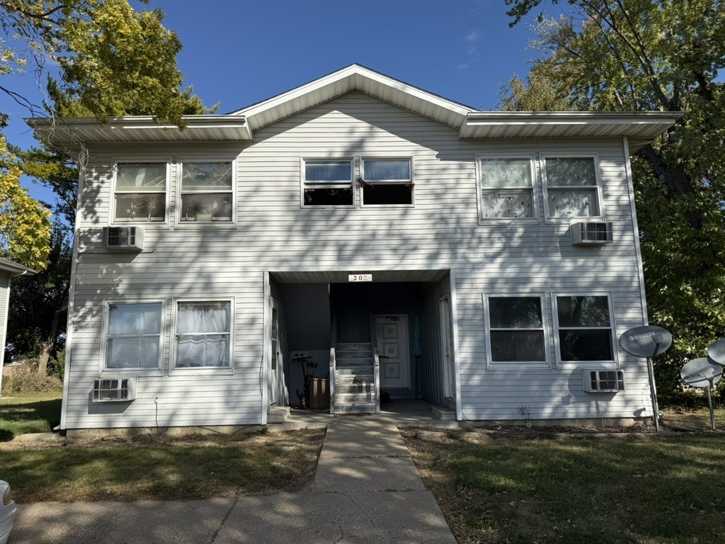 A two-story house with a garage on the ground floor.