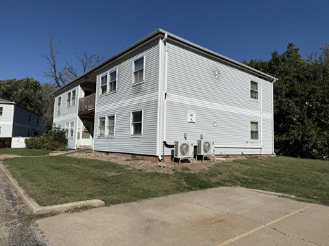 A two-story house with a garage on the side.