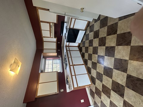A staircase with a checkered floor pattern.
