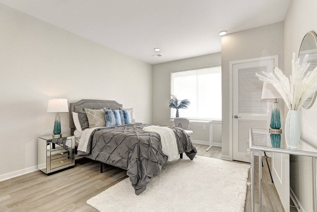 a bedroom with gray walls and a white rug