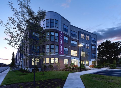 A modern building with a curved facade and a sign that reads "Lorette".
