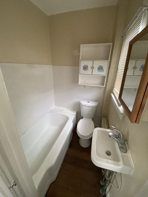 a small bathroom with a sink toilet and bath tub