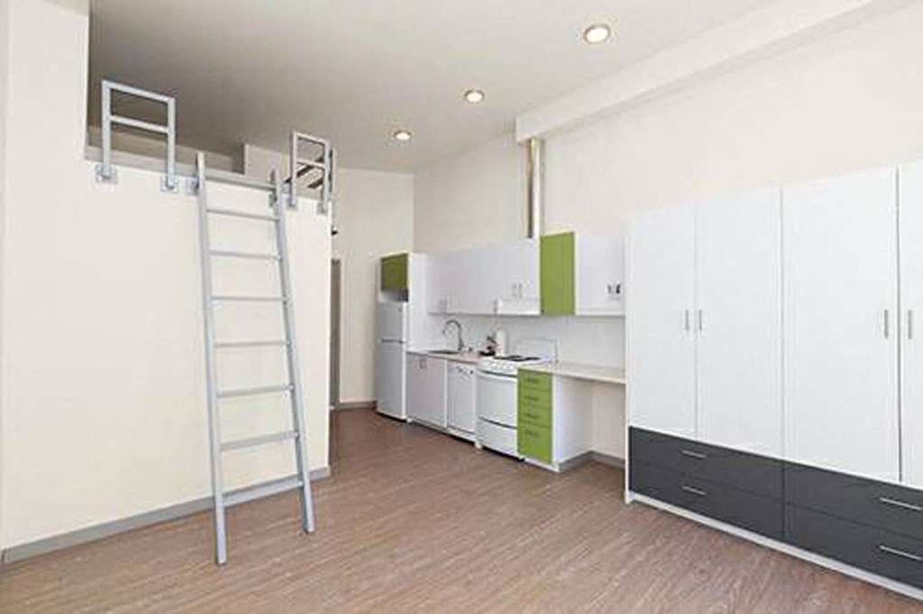 a white kitchen with a ladder in the middle of it