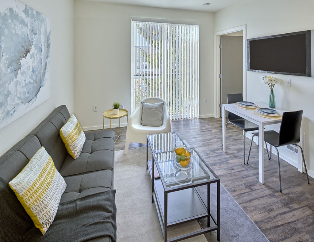 a living room and dining room with a couch and a table