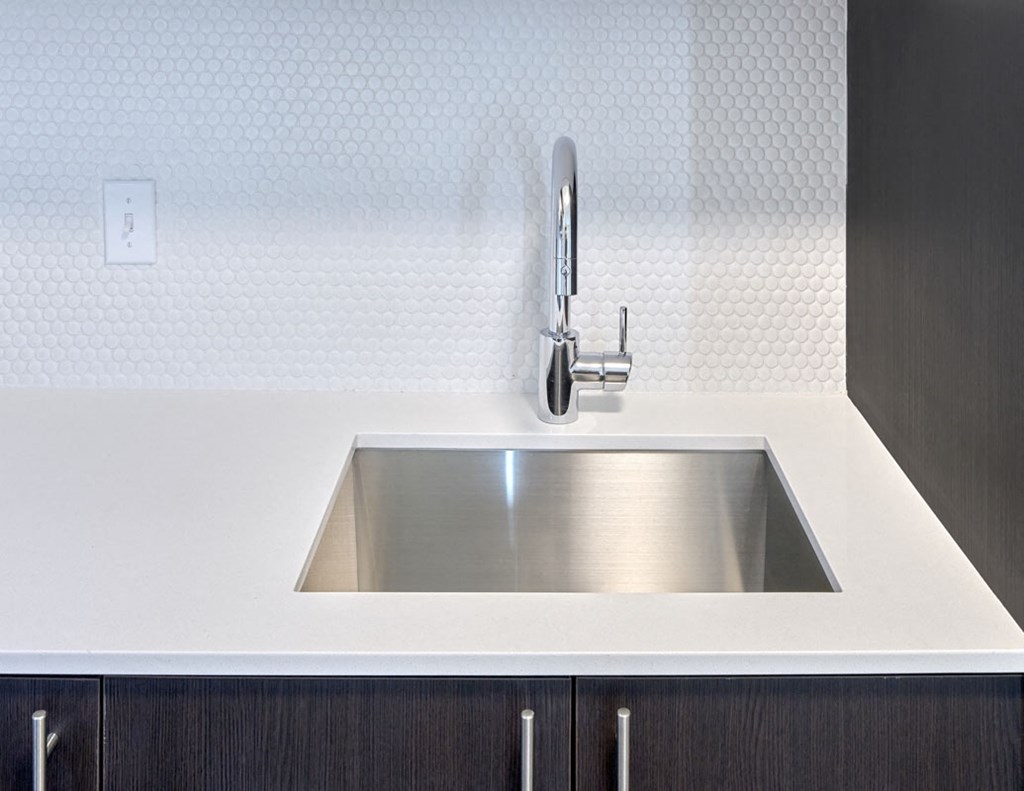 a stainless steel sink in a kitchen with a faucet