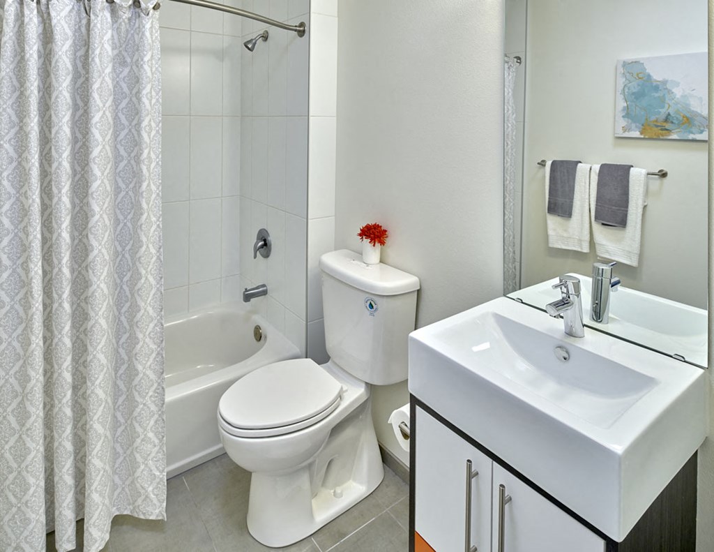 a bathroom with a toilet and a tub and a sink