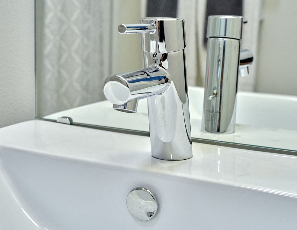 a bathroom with a sink and a faucet