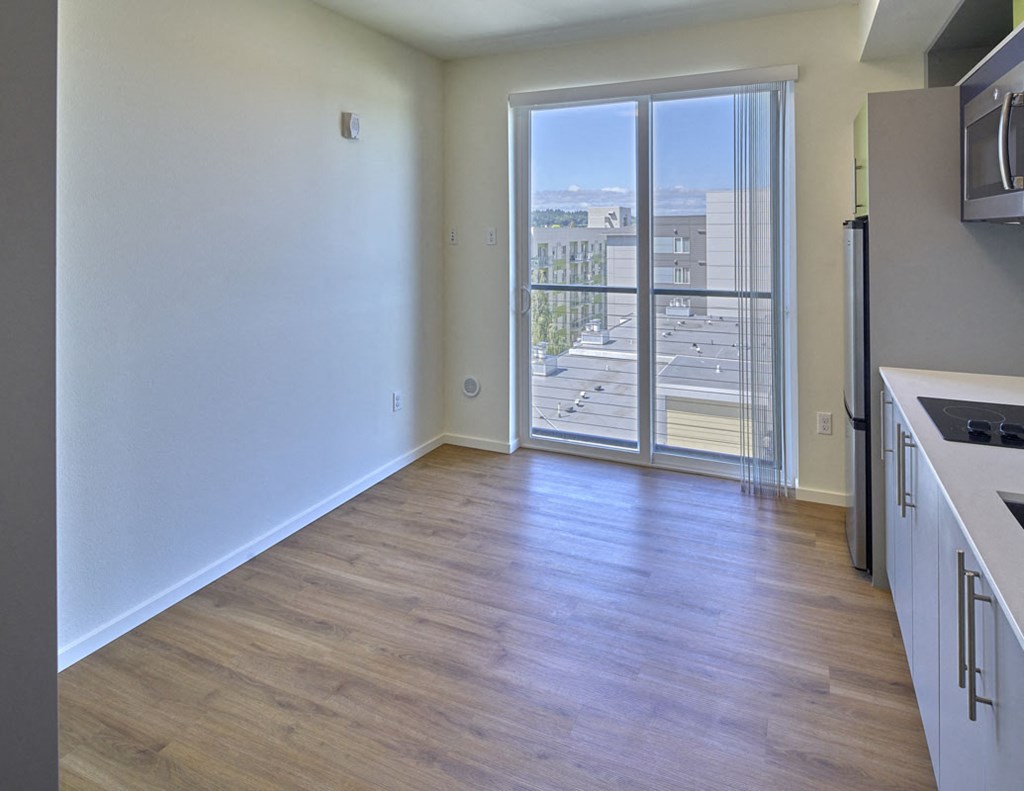 an empty kitchen with a door to a balcony