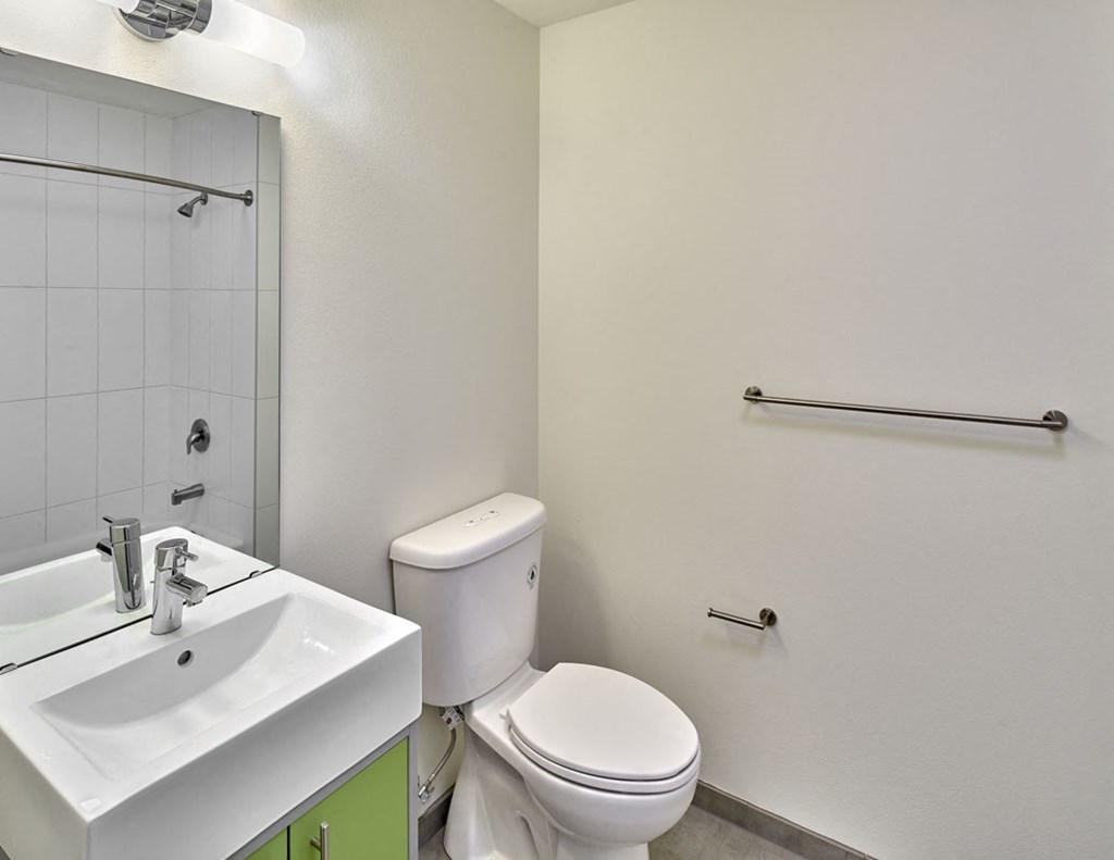 a bathroom with a toilet sink and a mirror