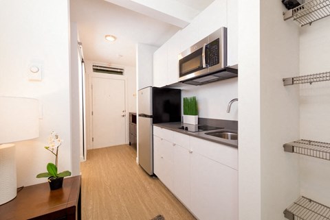 a small kitchen with a sink and a microwave
