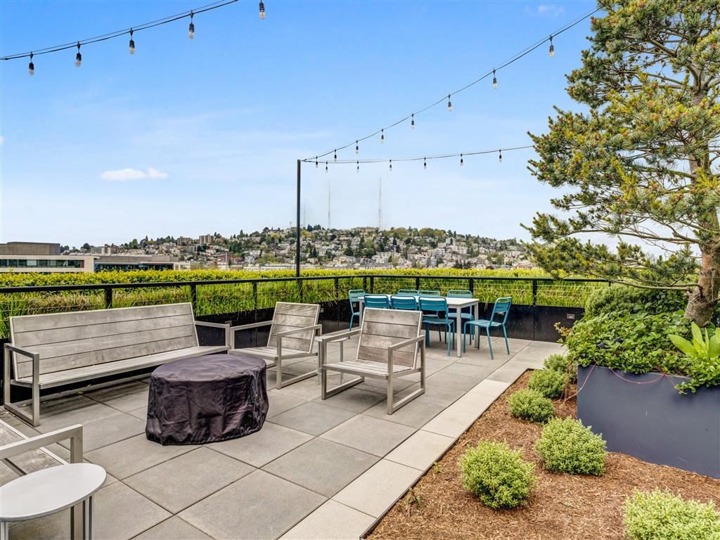 a patio with a table and chairs and a view