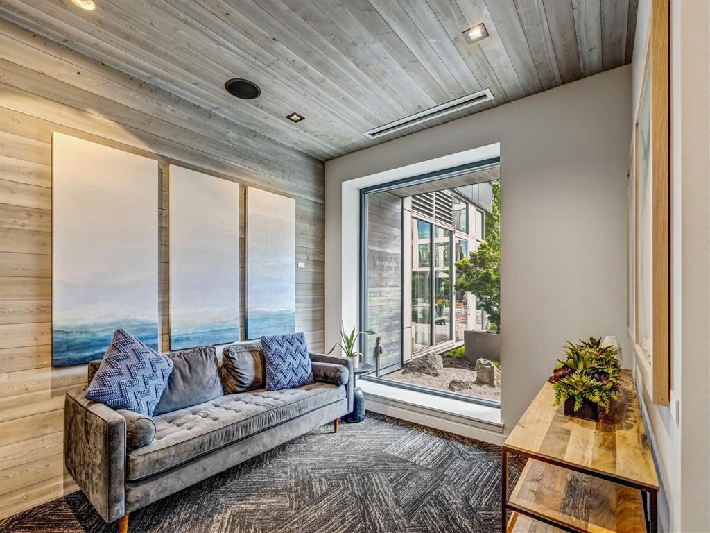 a living room with a couch and a window overlooking the ocean