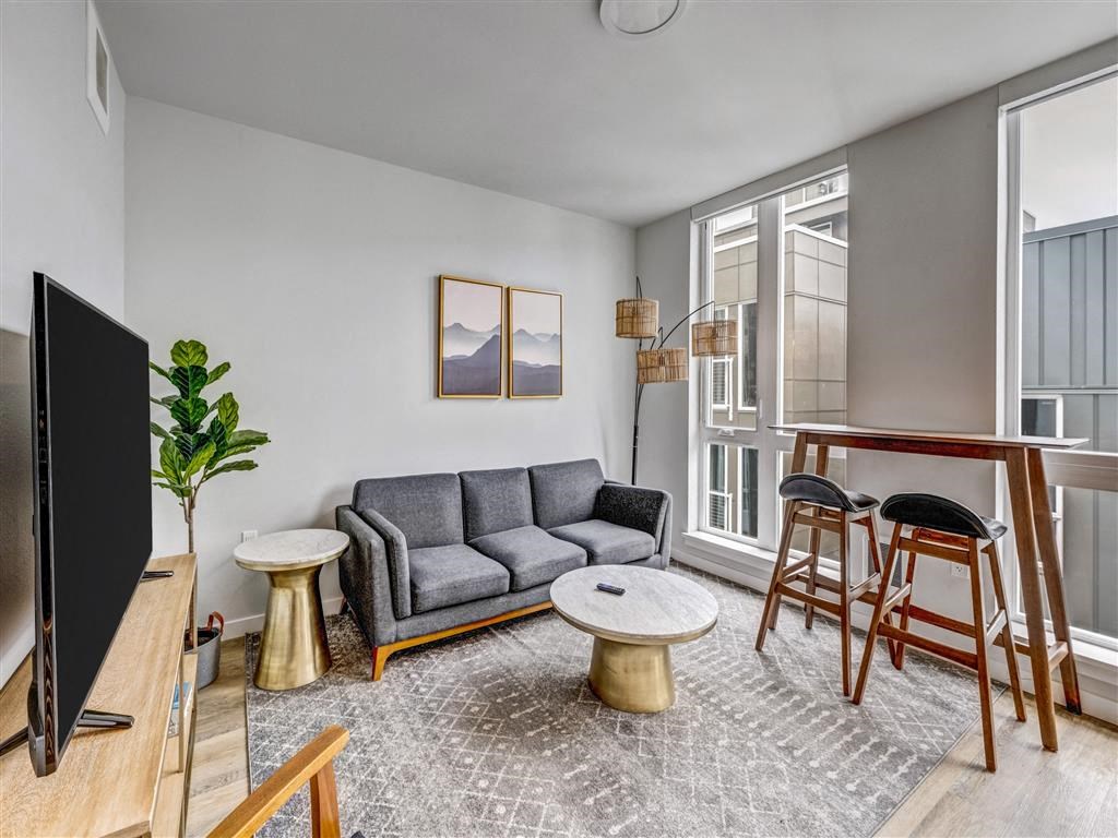 a living room with a couch and a bar and a tv