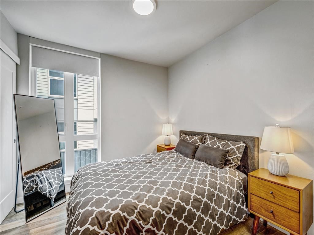 a bedroom with a bed and a mirror