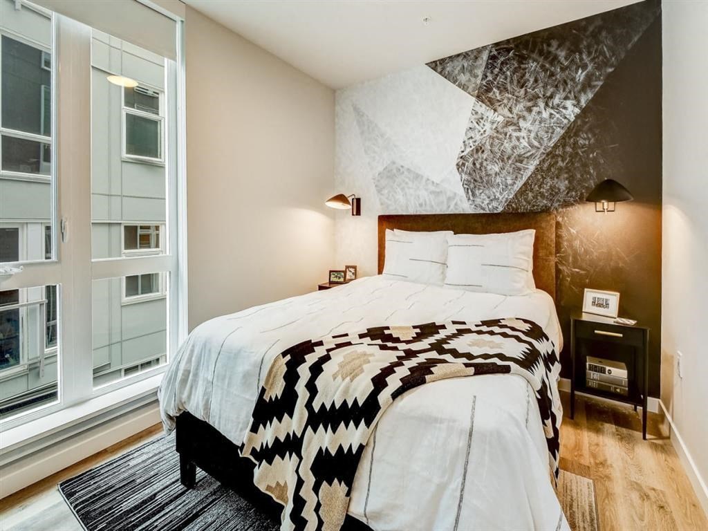 a bedroom with a bed and a large window