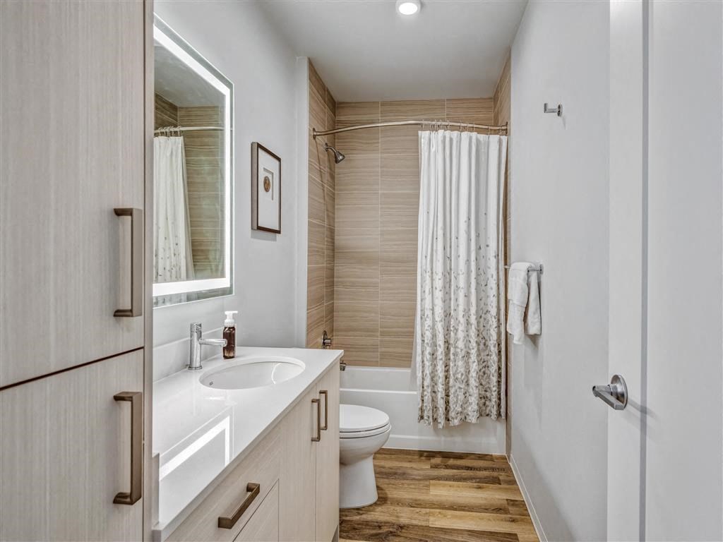 a bathroom with a sink and a toilet and a shower