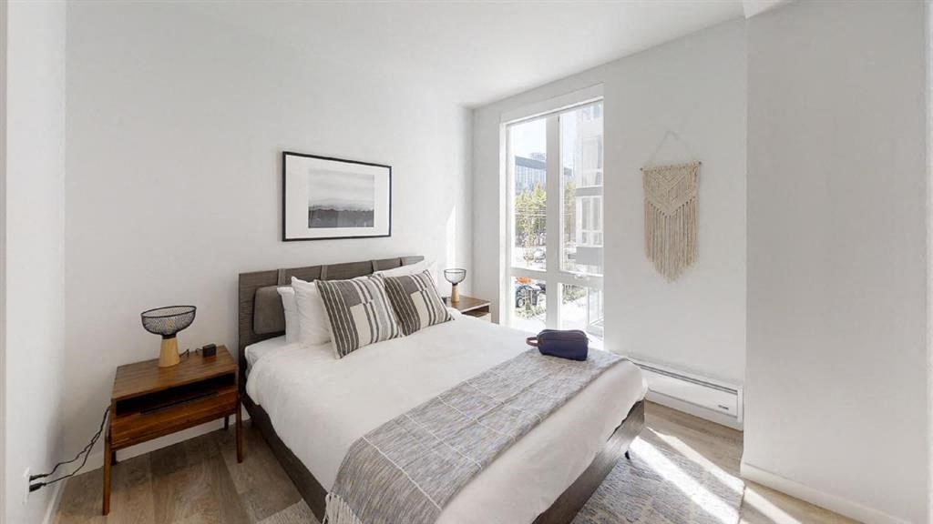 a bedroom with a bed and a window