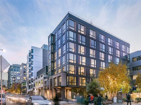 a rendering of a tall building on a city street