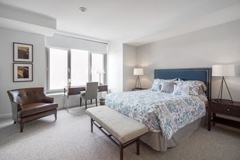 a bedroom with a bed and a chair and a window  at HIGHGROVE, Stamford, CT, 06901