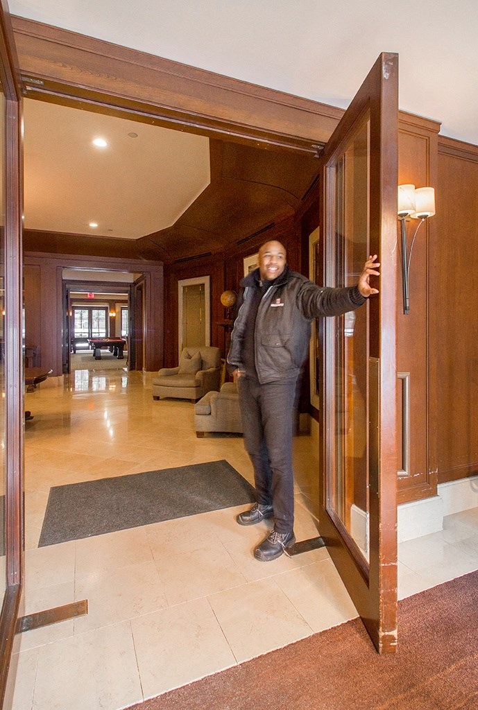 a man standing in a door way in a lobby at HIGHGROVE, Stamford, CT