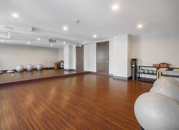 a yoga room with a hard wood floor and a yoga ball  at HIGHGROVE, Stamford, CT