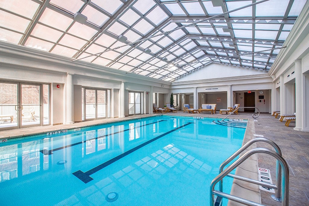 a swimming pool under a glass ceiling in a large room at HIGHGROVE, Connecticut