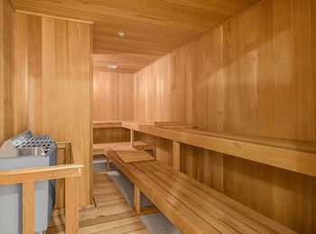 a sauna room with wooden benches and a sink  at HIGHGROVE, Stamford, CT, 06901