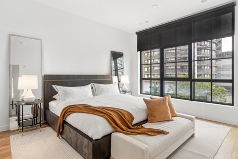 a bedroom with a large bed and a large window