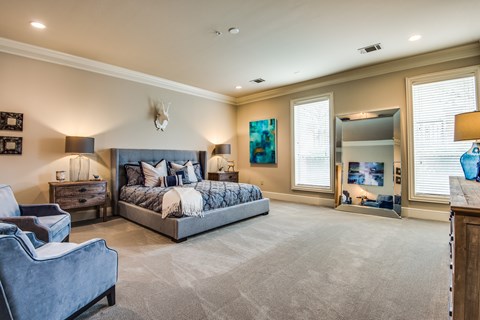 A bedroom with a large bed and a couch.