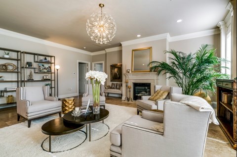 A living room with a fireplace and a large mirror on the wall.