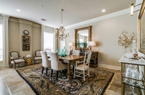A dining room with a table set for six.