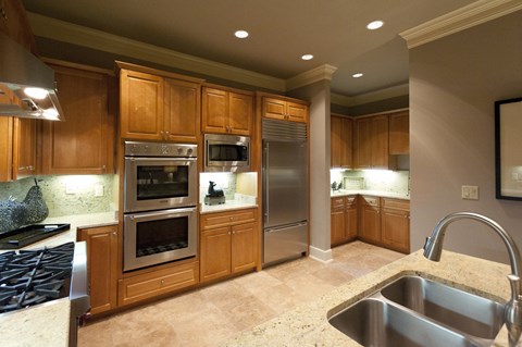 A kitchen with wooden cabinets and stainless steel appliances.