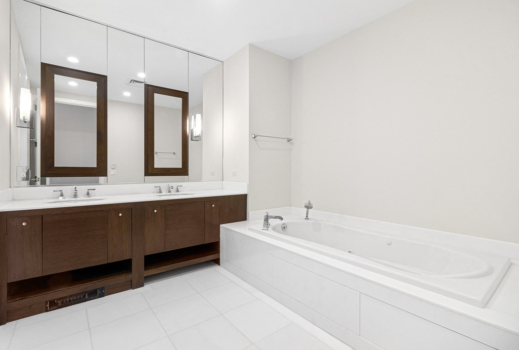 a large white bathroom with a tub and two sinks at HIGHGROVE, Connecticut