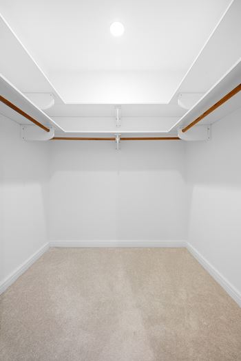an empty room with white walls and a beige carpet at HIGHGROVE, Stamford, CT, 06901