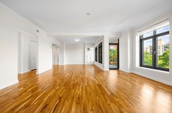 a living room with a hard wood floor and large windows at HIGHGROVE, Connecticut