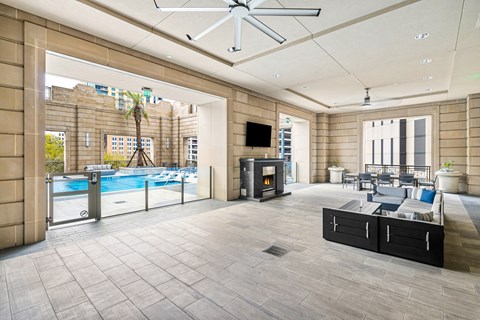 A large, modern room with a pool and a television.
