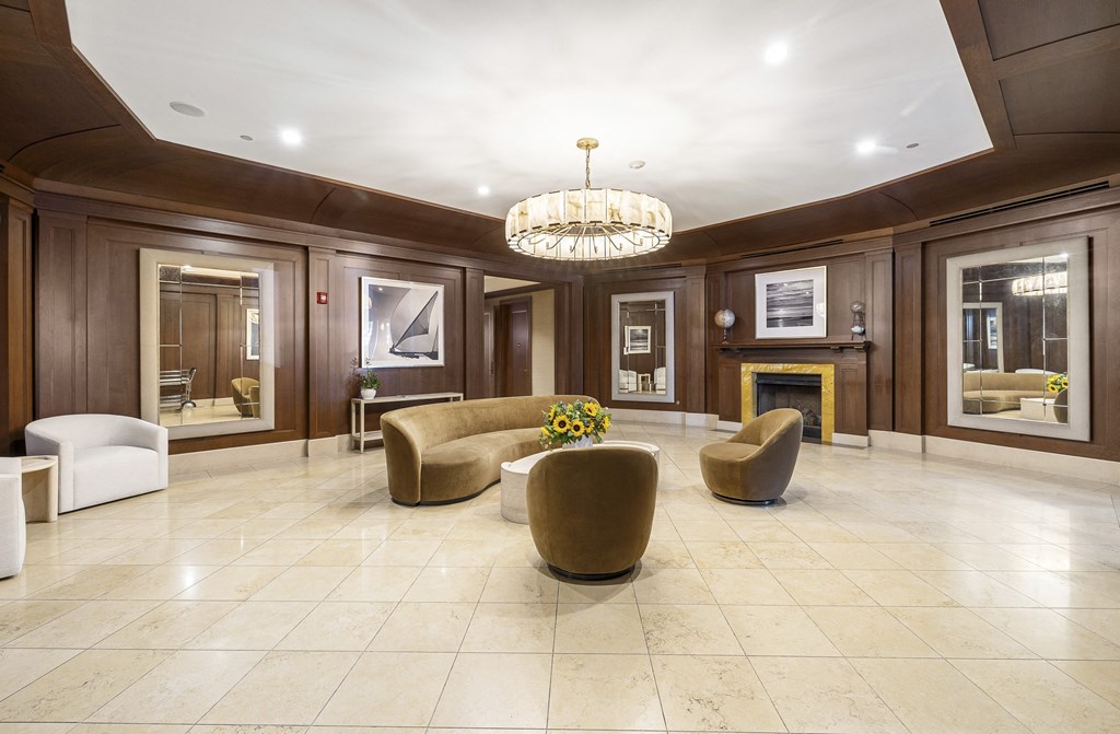 a living room with couches and chairs and a fireplace at HIGHGROVE, Stamford, CT