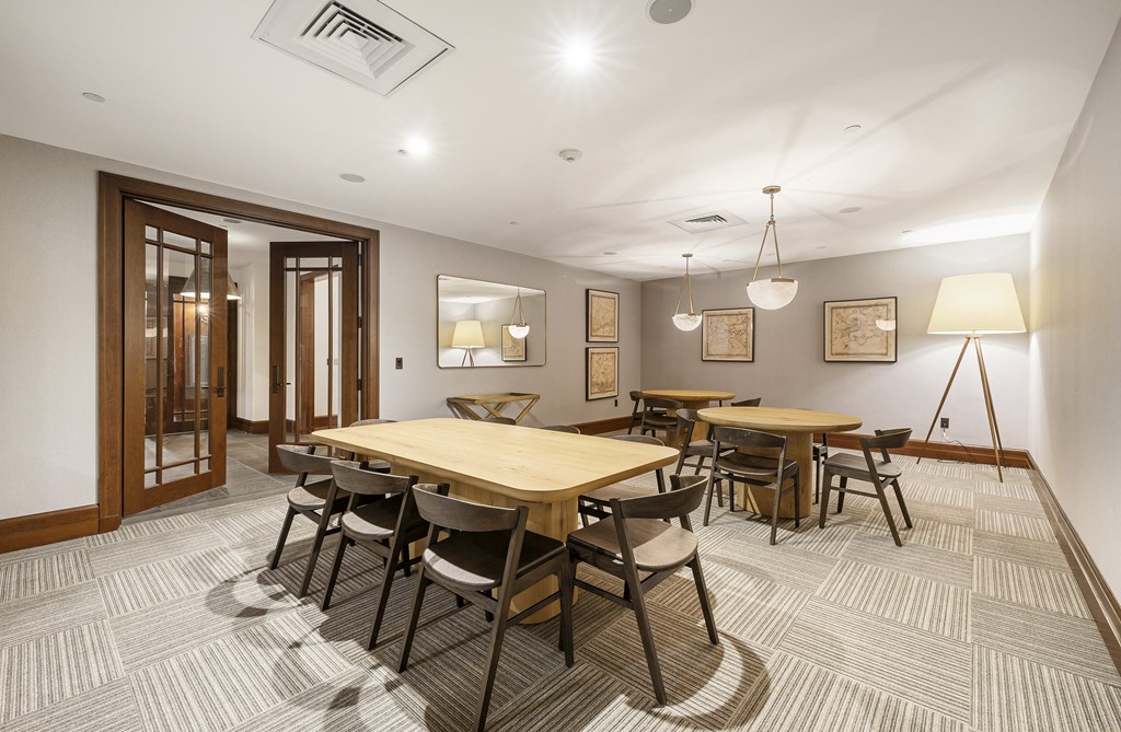 a dining room with a wooden table and chairs at HIGHGROVE, Stamford, 06901