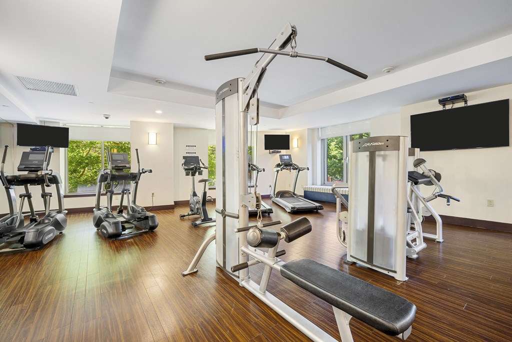 a gym with treadmills and other exercise equipment on a wooden floor at HIGHGROVE, Connecticut
