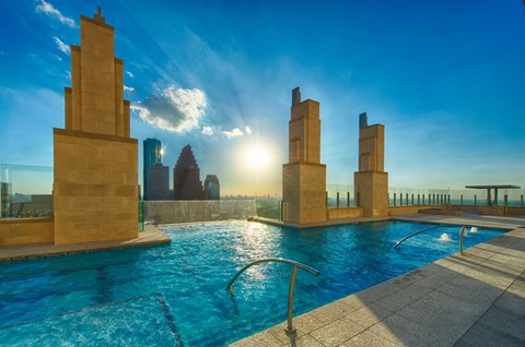 A sunny day at the pool with a sunset in the background.