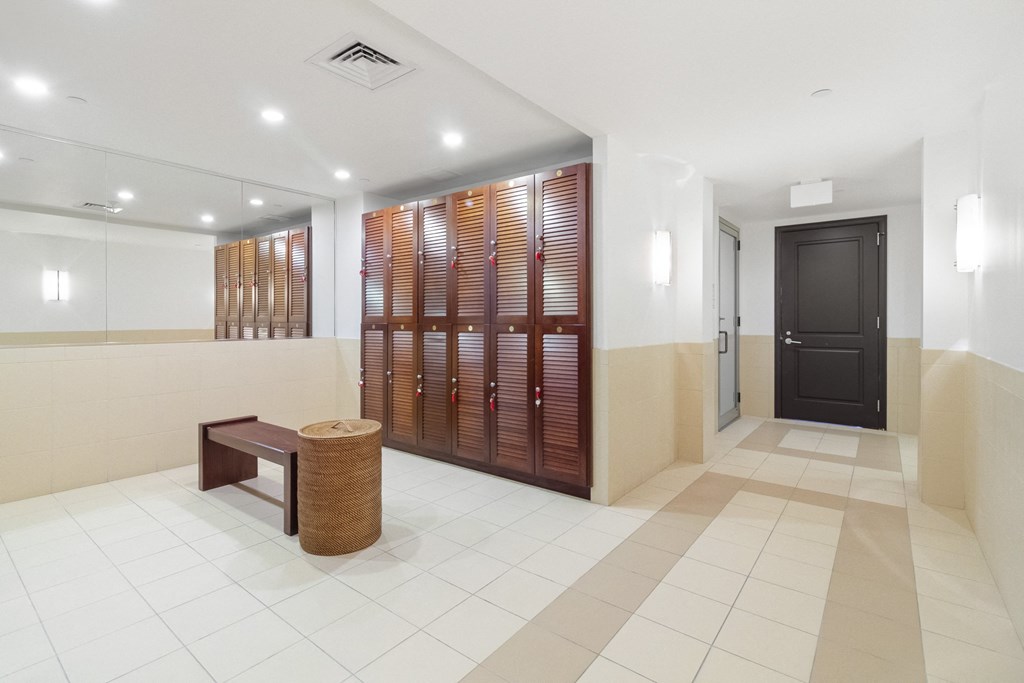 a lobby with a door to a locker room and a bench  at HIGHGROVE, Stamford, CT